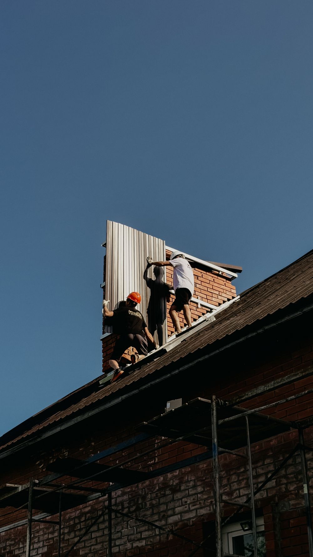 A crew installing panels on a residential roof