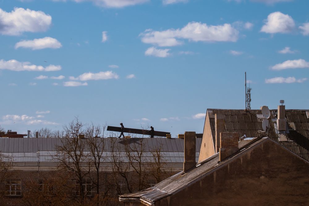 A roofline against a bright, storm-washed sky