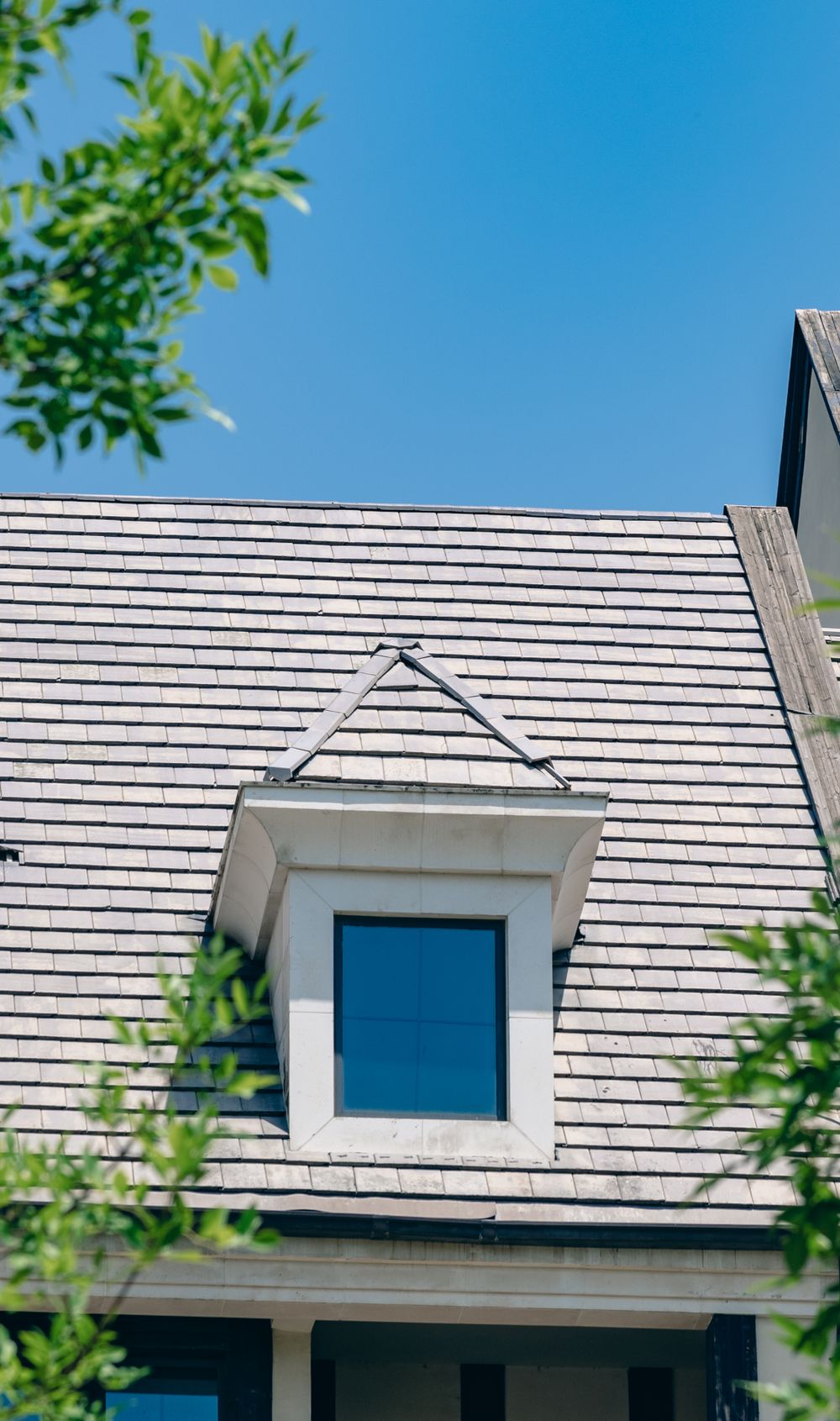 A dormer and ridge line on a shingled roof