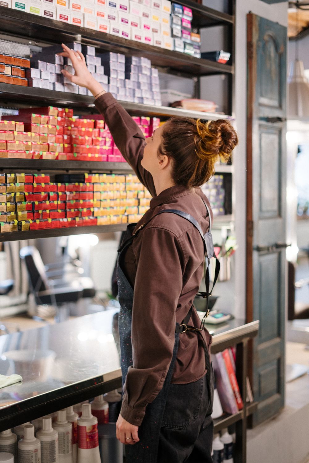 A stylist selecting colour from the studio shelves