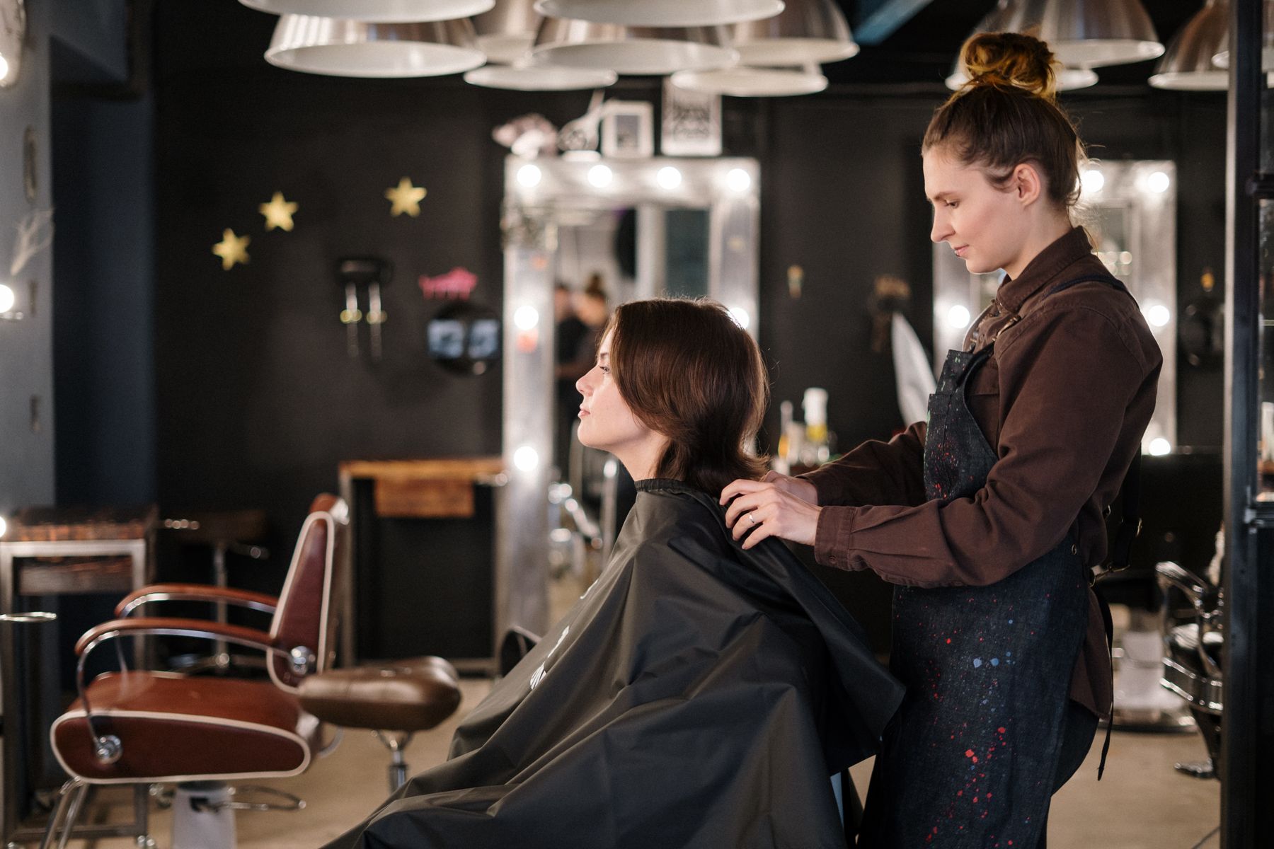 A stylist cutting a client's hair in the studio
